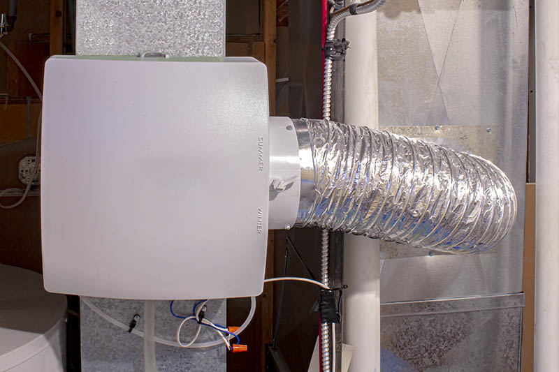 A home humidifier attached to the return duct with a bypass connection to the supply hot air duct. IAQ Humidifiers Supporting 800x533 1