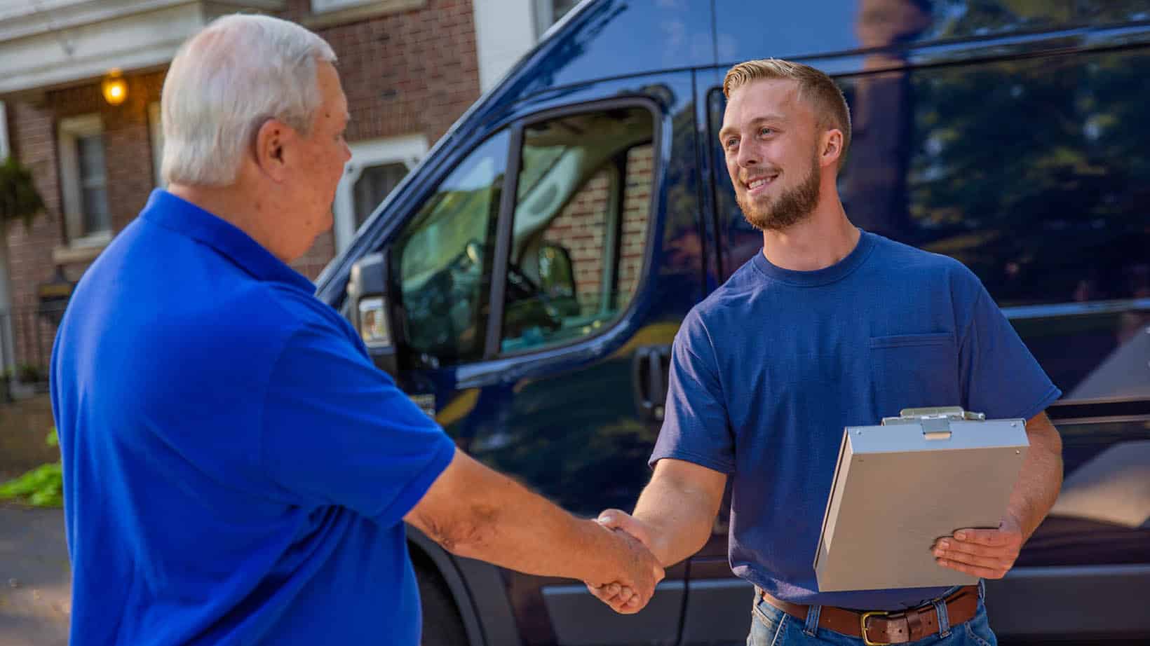ugi-AboutUs-Hero-1640×922 HVAC technician shaking the hand of a homeowner in front driveway